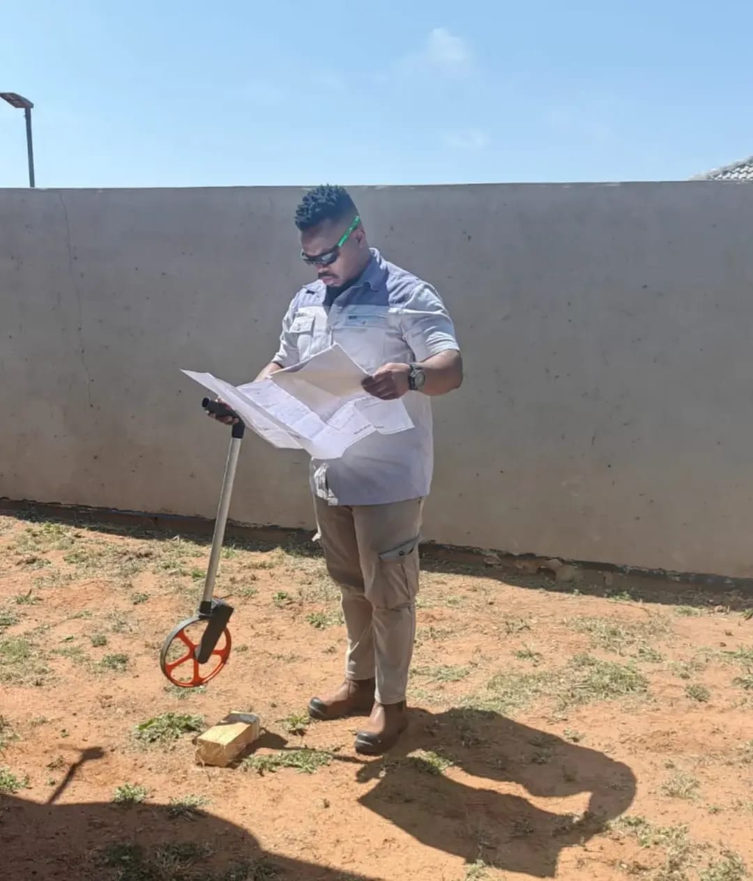 Measuring out a site with plans in hand