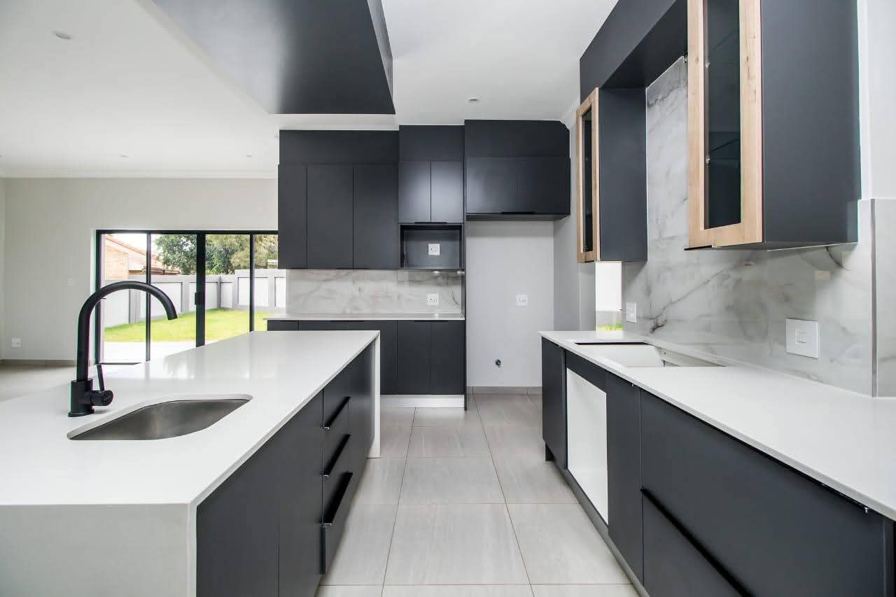 Modern kitchen with dark cabinetry and marble splashback