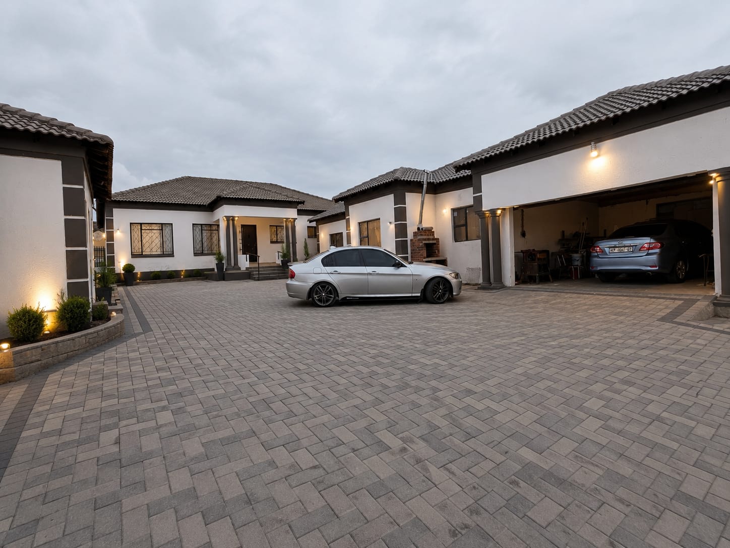 Finished homes with paved courtyard at dusk